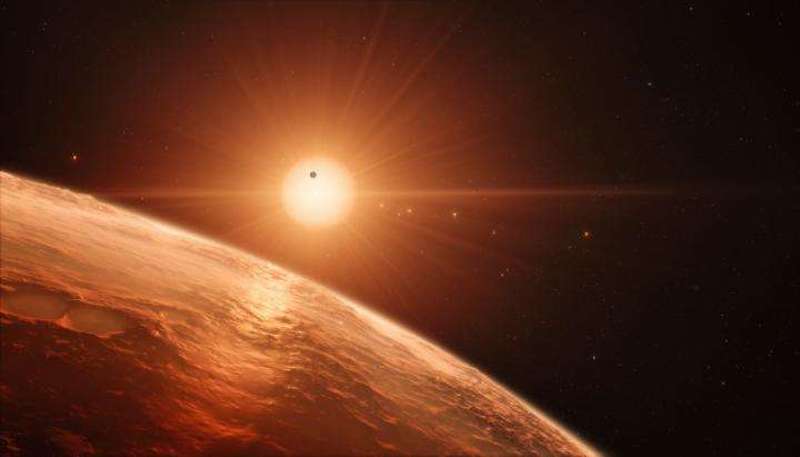 This artist's impression shows the view from the surface of one of the planets in the TRAPPIST-1 system. At least seven planets orbit this ultra cool dwarf star 40 light-years from Earth and they are all roughly the same size as the Earth. They are at the right distances from their star for liquid water to exist on the surfaces of several of them. Credit: ESO/M. Kornmesser  Read more at: https://phys.org/news/2017-02-temperate-earth-sized-worlds-extraordinarily-rich.html#jCp